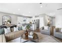 Bright and airy living space showcases an open layout with modern furniture, a dining area, and a stylish kitchen at 147 Park Lane Ln, Fairburn, GA 30213