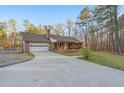 Lovely brick home with garage, inviting covered front porch, and extended concrete driveway at 6890 Cedar Mountain Rd, Douglasville, GA 30134