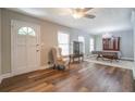 Sunlit living room features wood floors, neutral walls, and a decorative display cabinet at 411 Burke Cir, Mcdonough, GA 30253