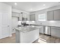 Modern kitchen with granite island, stainless steel appliances, and white cabinets at 159 Park Lane, Fairburn, GA 30213