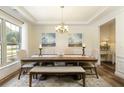 Traditional dining room features wood floors, neutral walls, and a large window for lots of natural light at 200 Bexley Pkwy, Tyrone, GA 30290