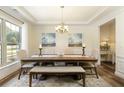 Bright dining room featuring elegant lighting and large windows at 200 Bexley Pkwy, Tyrone, GA 30290