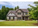 Charming two-story home with a well-kept lawn and traditional brick and siding exterior at 200 Bexley Pkwy, Tyrone, GA 30290