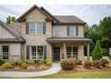 Beautiful two-story brick home with a covered porch and manicured landscaping at 200 Bexley Pkwy, Tyrone, GA 30290