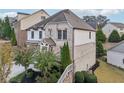 Attractive angle of a two-story residence with a two-car garage and beautifully maintained yard at 11760 Stratham Dr, Alpharetta, GA 30009