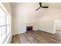Open living area with high ceiling, fireplace, and large windows for natural light at 2192 Stenger Rd, Douglasville, GA 30135