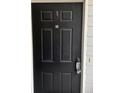 Close-up of a black front door with security lockbox and unit number 124 at 124 Streamside Dr # 24, Roswell, GA 30076