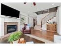 Cozy living room features a brick fireplace, hardwood floors, staircase, and a comfortable leather armchair at 2207 Derbyshire Sw Dr, Marietta, GA 30064