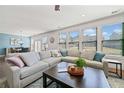 Bright living room featuring a large sectional sofa, numerous windows, and a dining space in the background at 2207 Derbyshire Sw Dr, Marietta, GA 30064