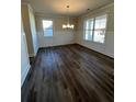 Bright dining room with modern lighting, chair rail, and large windows at 3687 Lockaby Way, Lawrenceville, GA 30044