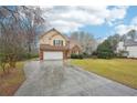 Traditional two-story home featuring a two-car garage, lush lawn, and a welcoming front entrance at 381 Gates Mil Dr, Lawrenceville, GA 30045