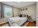 Comfortable bedroom featuring a window with blinds and hardwood floors at 2350 Brenda Se Dr, Smyrna, GA 30080