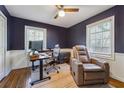 Comfortable home office with hardwood floors, wainscoting, a ceiling fan, and a brown leather reclining chair at 2350 Brenda Se Dr, Smyrna, GA 30080
