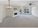 Spacious living room featuring a fireplace and neutral gray carpet at 107 Red Barn Ln, Acworth, GA 30102