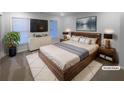 Well-lit primary bedroom with king bed, large TV, and stylish decor at 107 Red Barn Ln, Acworth, GA 30102