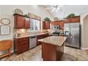 Well-lit kitchen with custom cabinets, stainless steel appliances, and a granite island at 1119 Simonton Glen Way, Lawrenceville, GA 30045