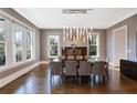 Bright dining room with modern chandelier, sleek furniture, and hardwood floors at 18 Polo Ne Dr, Atlanta, GA 30309