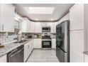 Updated kitchen featuring granite countertops, white cabinetry and stainless steel appliances at 2831 Spruce Point Rd, South Fulton, GA 30349