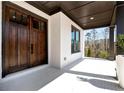 Inviting front porch with double doors, painted white brick, dark trim, and ample natural light at 320 Dodd Ln, Alpharetta, GA 30005