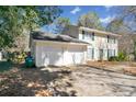 A two-story home boasting an attached two-car garage and well-maintained landscaping at 4401 Shiloh Hills Dr, Snellville, GA 30039