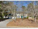 Traditional two-story home with a two-car garage, green shutters, and a driveway at 4401 Shiloh Hills Dr, Snellville, GA 30039