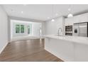 Open-concept kitchen with white cabinets, stainless steel appliances, and island at , Mcdonough, GA 30253