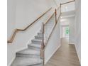 Bright staircase with carpeted steps and wooden banister at , Mcdonough, GA 30253
