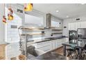 Bright kitchen with stainless steel appliances, island sink, modern cabinets and floating wood shelves at 560 John Wesley Dobbs Ave, Atlanta, GA 30312