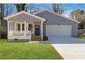 Charming home with a covered front porch, attached garage, and a well-maintained lawn at 2195 Springdale Sw Rd, Atlanta, GA 30315