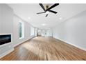 Bright open-concept living room with hardwood floors, modern fireplace, and an adjacent kitchen at 2195 Springdale Sw Rd, Atlanta, GA 30315