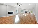 Bright open-concept living room with hardwood floors, modern fireplace, and an adjacent kitchen at 2195 Springdale Sw Rd, Atlanta, GA 30315