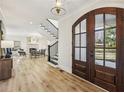 Bright foyer with hardwood floors leads to living room, fireplace, and staircase at 510 Forest St, Buford, GA 30518