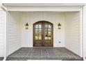 Close up of beautiful arched double front doors with sidelights and stone porch at 510 Forest St, Buford, GA 30518