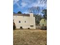 A large, well-maintained backyard with a full-size chimney, perfect for outdoor activities and relaxation at 956 S Deshon Rd, Lithonia, GA 30058