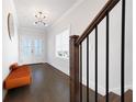 Well-lit foyer with wood floors, bench seating, white walls, and a staircase at 140 Rigby Ne St, Marietta, GA 30060