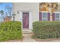 Entry to townhome with a storm door flanked by lush green bushes at 2510 Thorngate Dr, Acworth, GA 30101