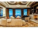 Bright and spacious living area featuring large windows with city views, a fireplace, and elegant chandelier lighting at 3376 Peachtree Ne Rd # 56, Atlanta, GA 30326