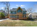 Beautiful two-story home featuring a stylish design, welcoming front porch, and manicured lawn at 561 Ashburton Ave, Decatur, GA 30032