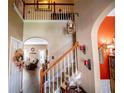 Hallway with staircase and views of the living room featuring hardwood floors and neutral paint at 613 Hemlock Ct, Villa Rica, GA 30180