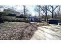 View of the home's lot, featuring an overgrown yard and detached garage at 1429 Funston Se Ave, Atlanta, GA 30315