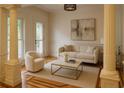 Living room with decorative columns, wainscoting, wood flooring, neutral furniture, and lots of light at 5531 Four Winds Sw Dr, Lilburn, GA 30047
