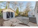 Backyard featuring a detached storage shed, concrete patio and landscaped areas at 1376 Westmont Sw Rd, Atlanta, GA 30311