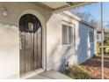 Close up of front door with arched frame, window and a covered porch with updated siding and trim at 1376 Westmont Sw Rd, Atlanta, GA 30311