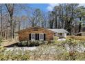 Charming brick home with black shutters and mature trees, creating a cozy and inviting curb appeal at 3080 Forrest Park Road Se, Atlanta, GA 30354