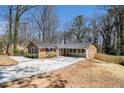 Well-maintained single-story home with a long driveway and fresh landscaping, offering great outdoor appeal at 3080 Forrest Park Road Se, Atlanta, GA 30354