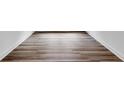 Close-up of modern hardwood flooring with clean white baseboards at 1356 Auburn Glen Rd, Dacula, GA 30019