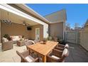 Comfortable covered patio space with wicker seating and dining table at 207 Tan Yard Rd, Social Circle, GA 30025