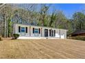 Inviting ranch-style house with a white brick facade and attached one-car garage at 4558 Ryan Rd, Conley, GA 30288