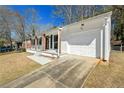 Attractive ranch-style home showcasing its attached garage and fresh white facade at 4558 Ryan Rd, Conley, GA 30288