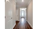 Elegant hallway with hardwood floors, crown molding, and recessed lighting leading to a bright entrance at 2628 Songbird Ln, Grayson, GA 30017